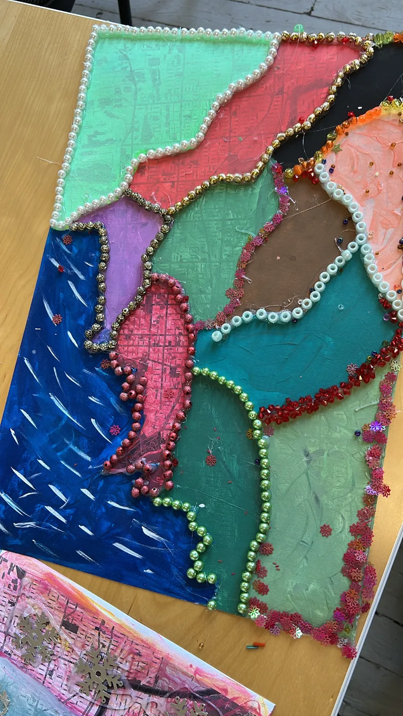 Textile collage with beads and stitching