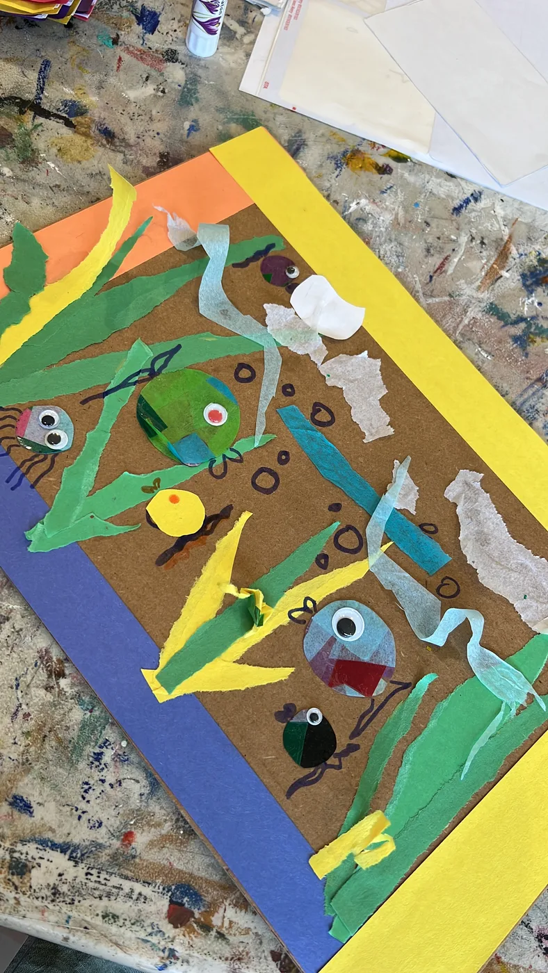 Paper collage of fish and seaweed with googly eyes