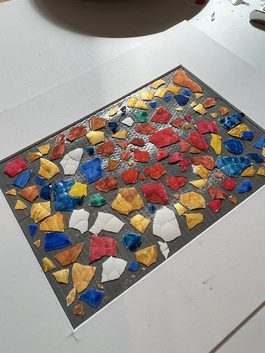 Eggshell mosaic in red, blue, gold and white