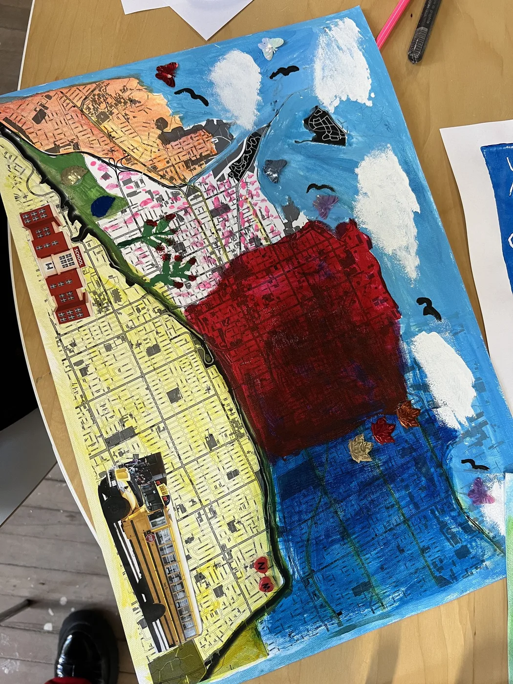 Map painted in red, yellow and blue with clouds