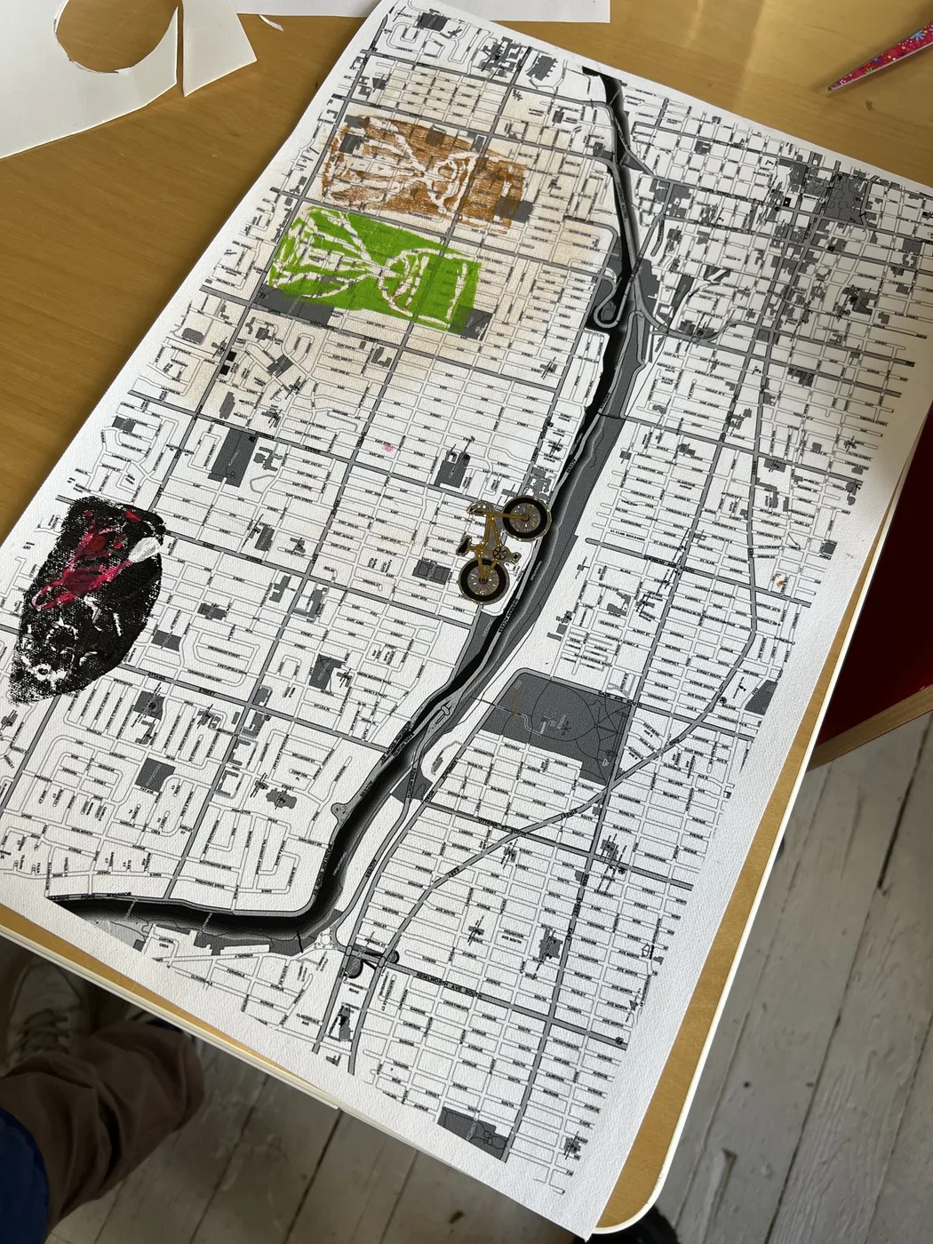Map collage with a black river and small cut-outs
