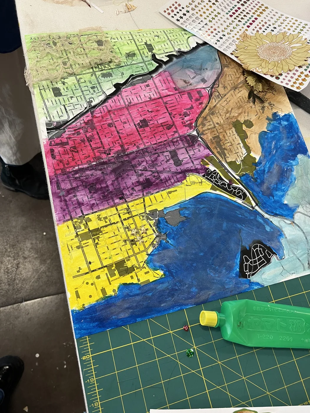 Map painted in pink, yellow and blue bands