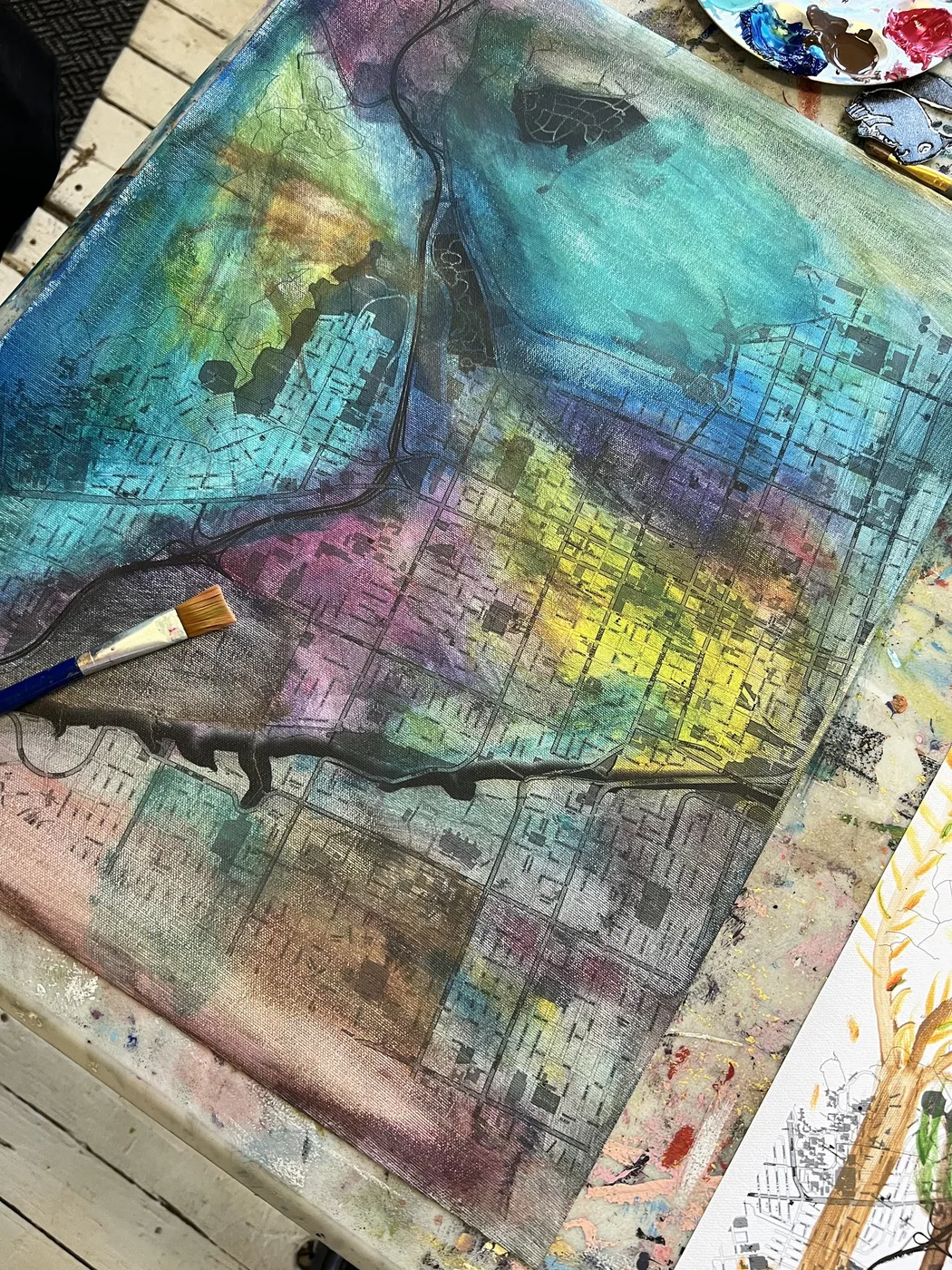 Map washed in blue, purple and yellow paint