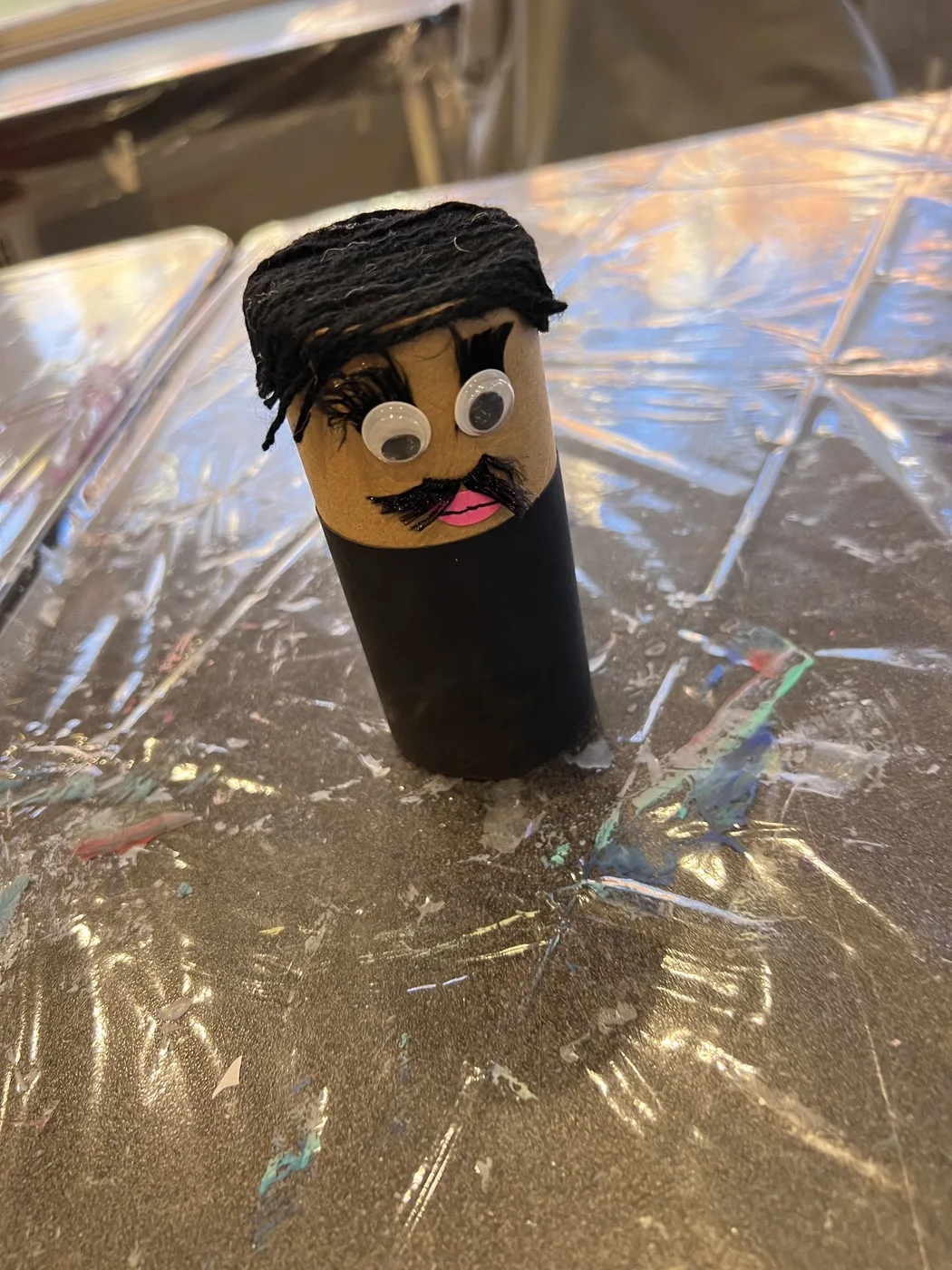 Tube figure with yarn hair and moustache