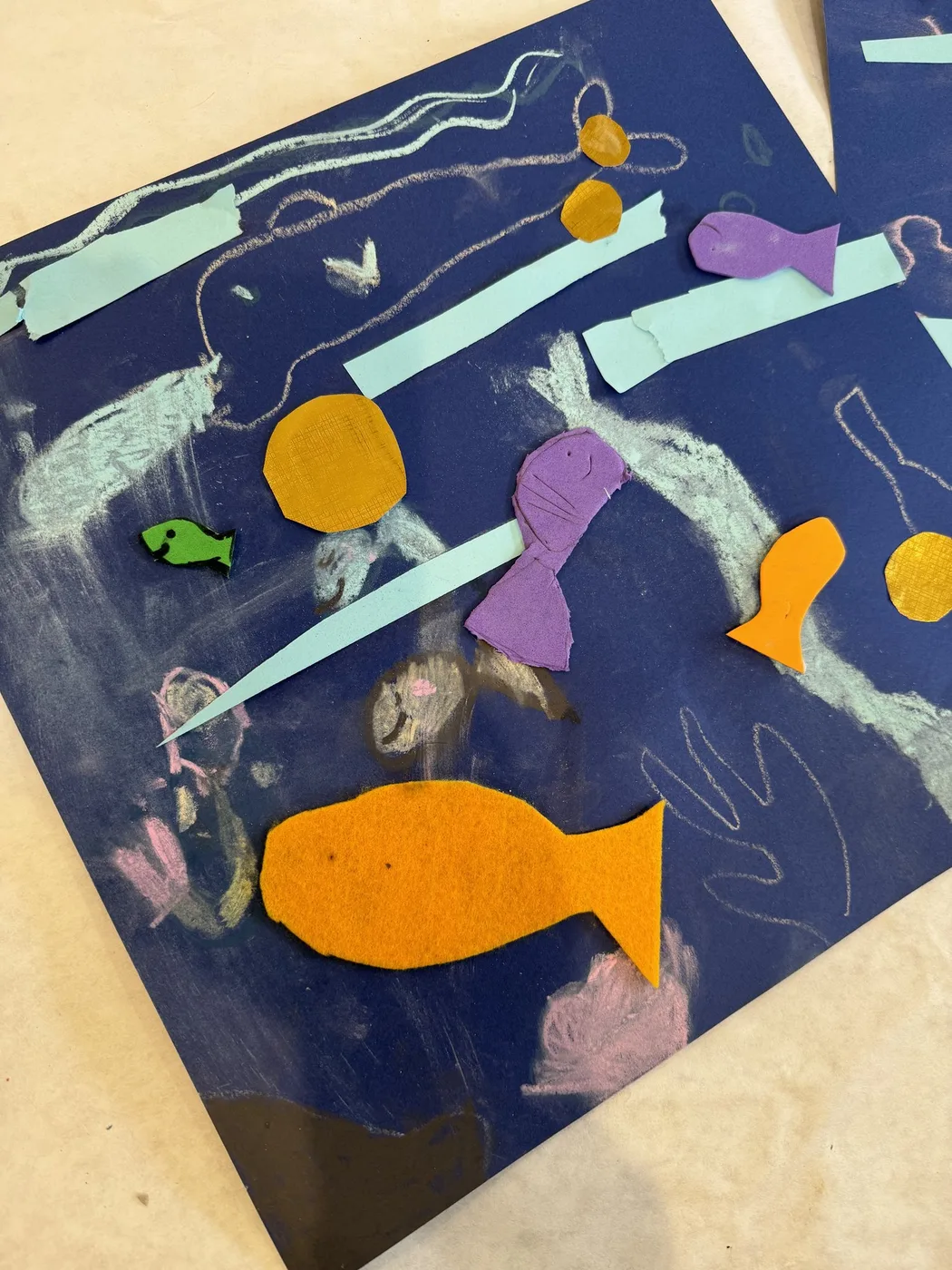 Underwater collage with paper fish on navy card