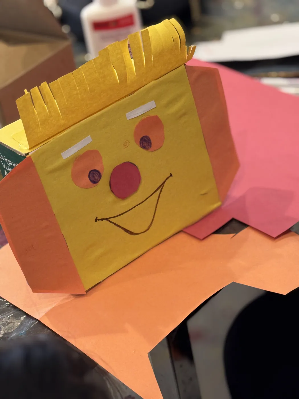 Yellow box character with fringed paper hair
