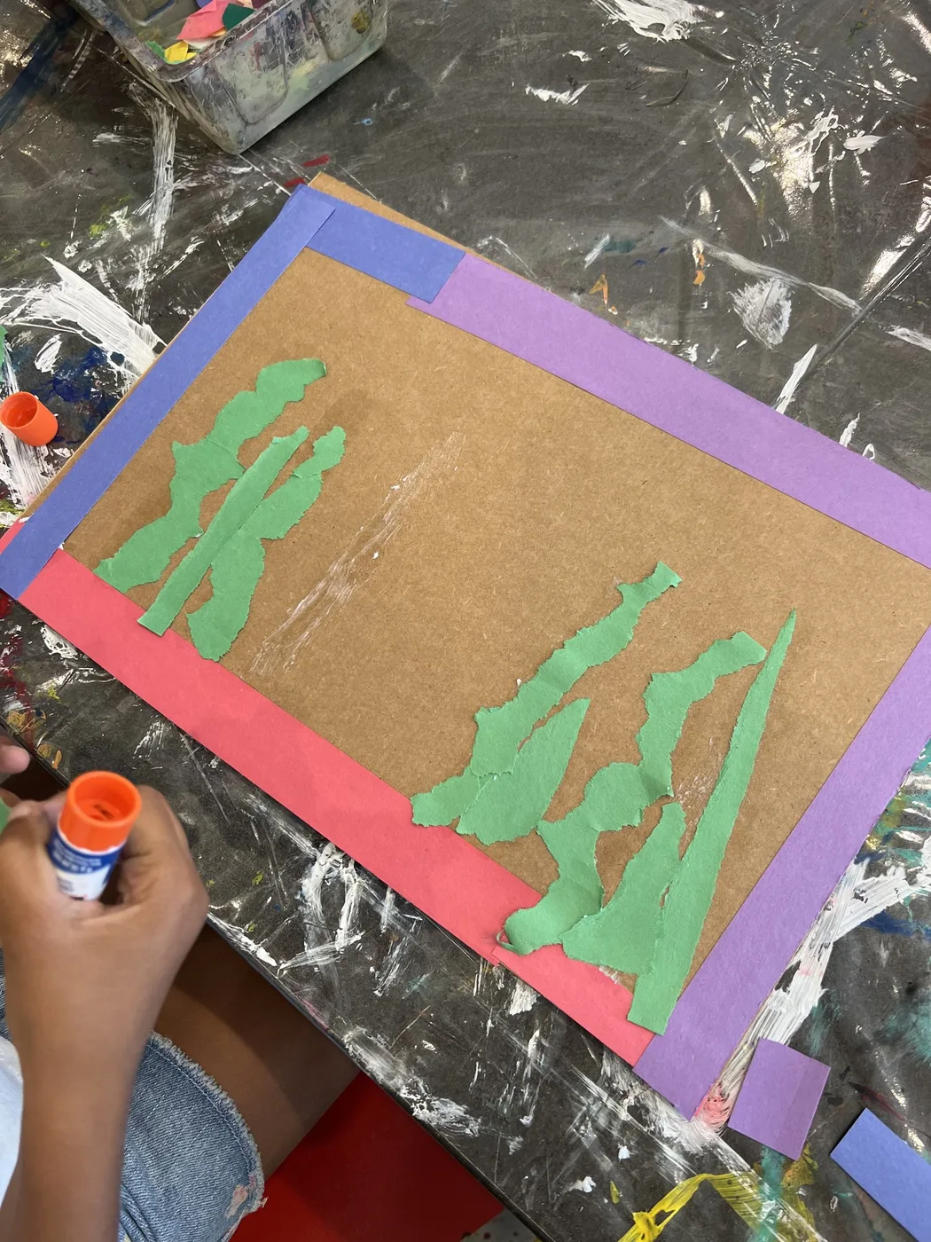 Green paper seaweed glued onto a framed cardboard sheet