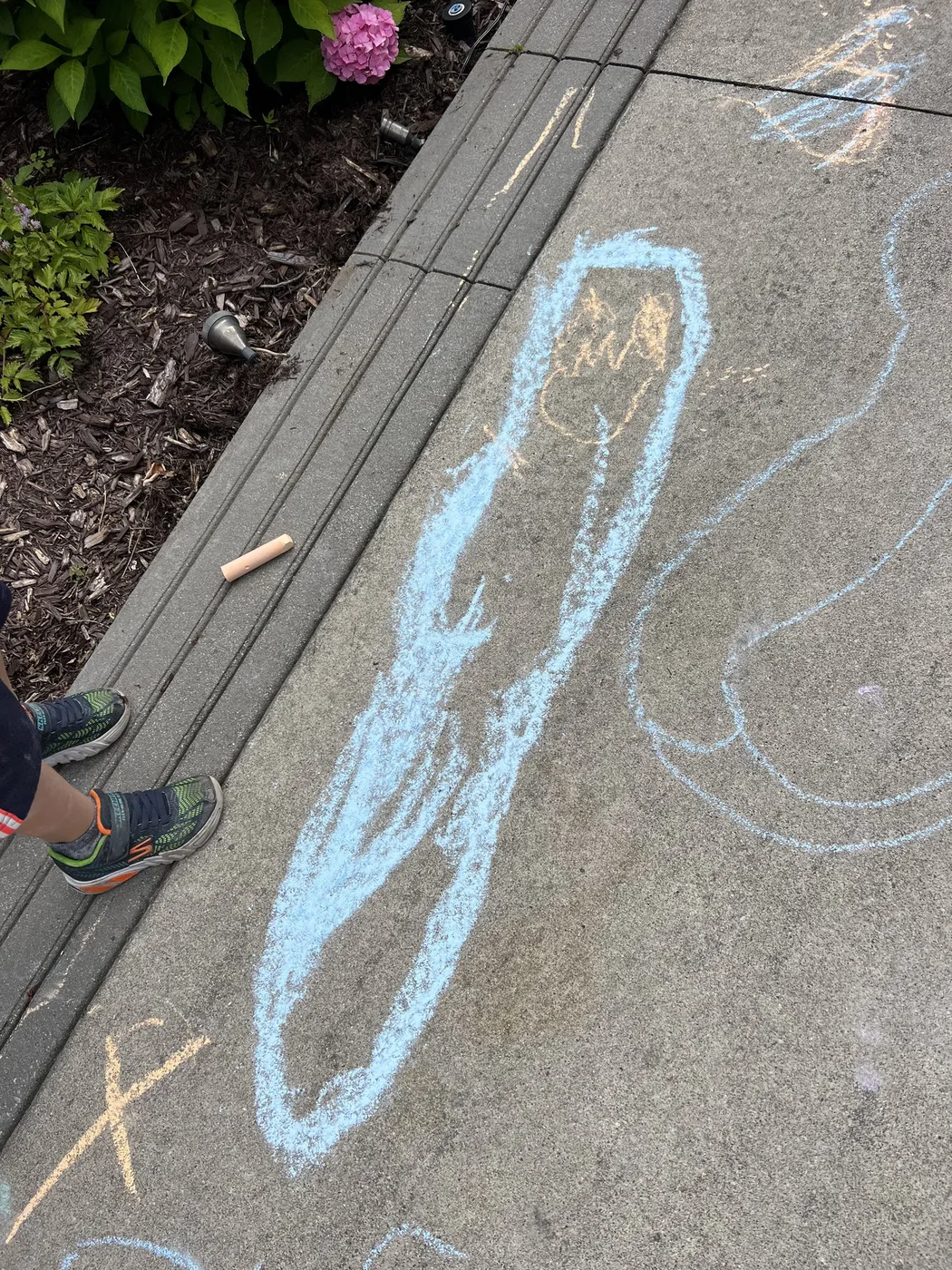 Blue chalk shape drawn along a pavement edge