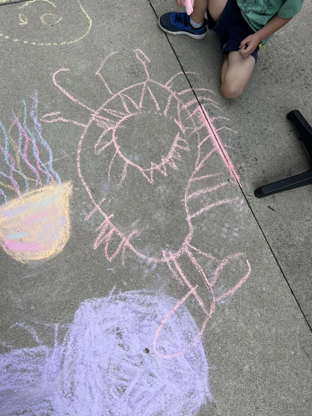 Chalk sun, jellyfish and purple blob on concrete