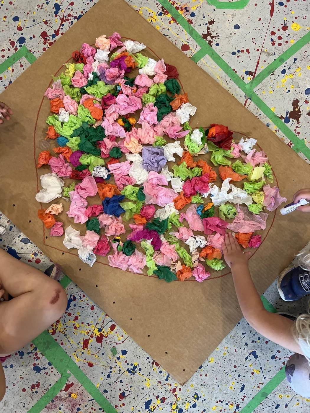 Crumpled tissue paper heart on cardboard