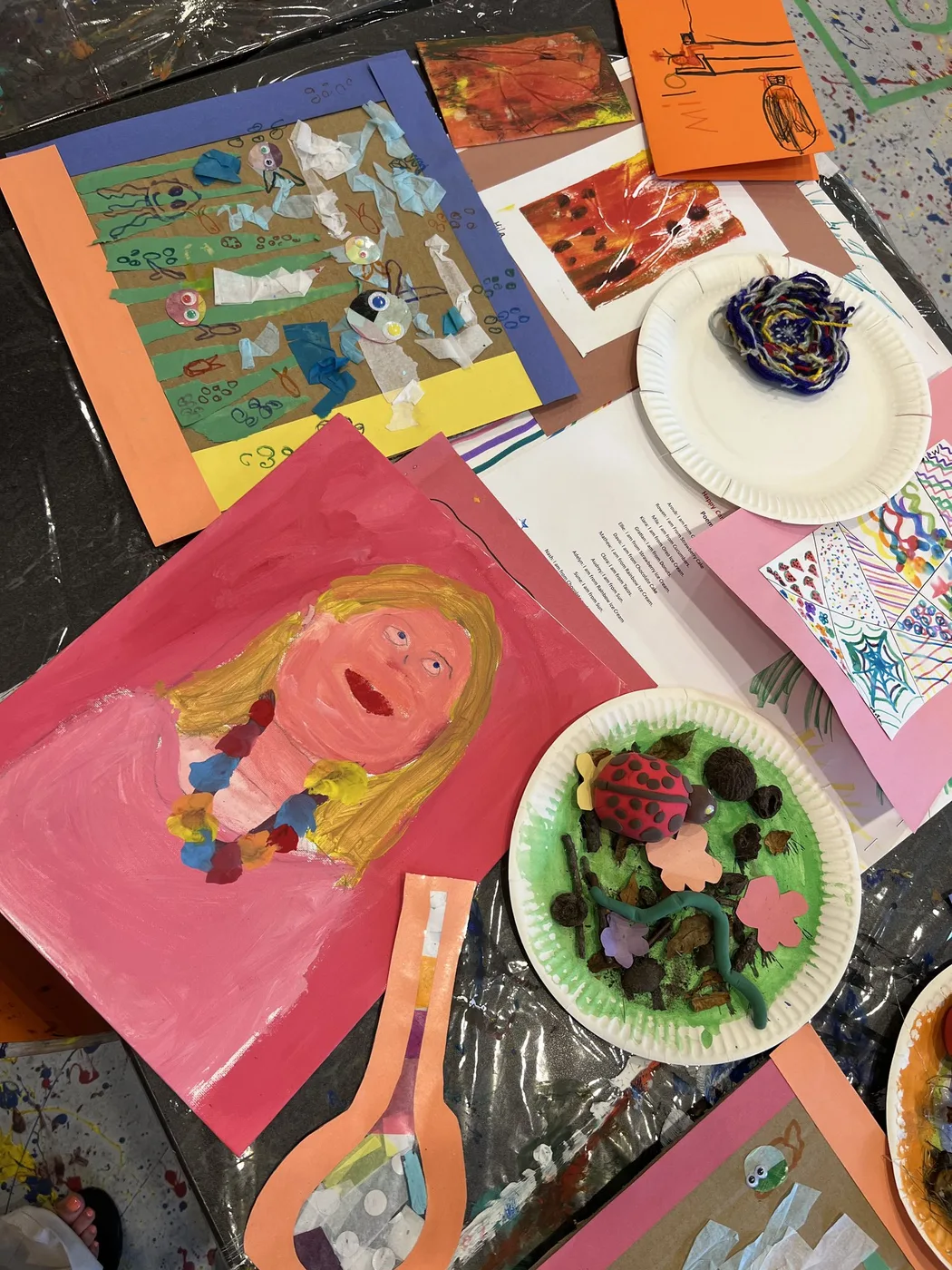 Camp portfolio with painted portrait and clay plate