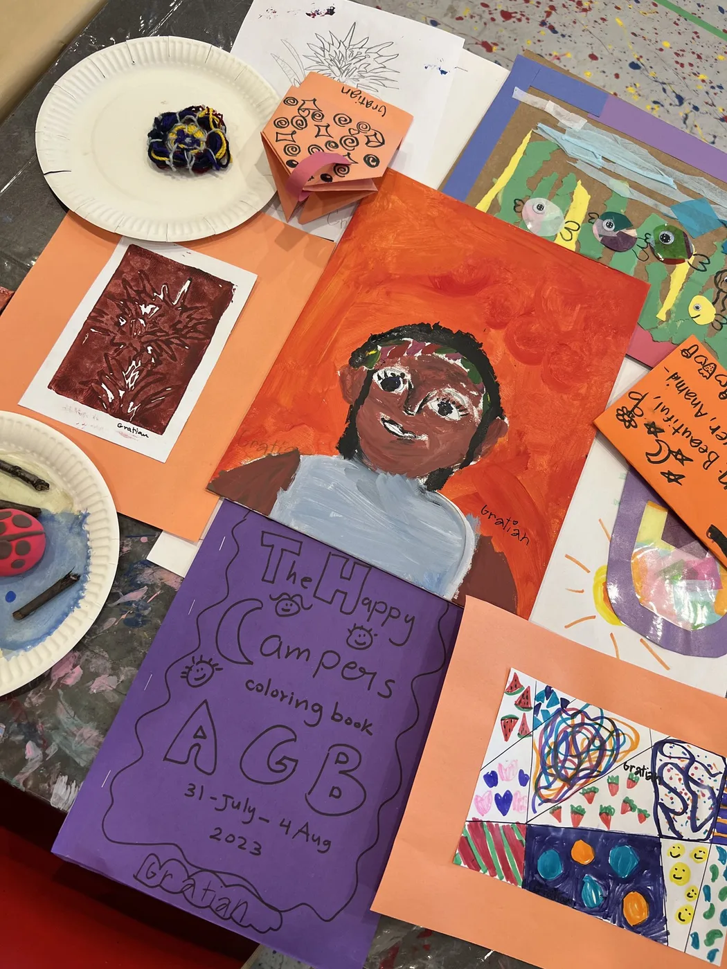 Camp portfolio with painted portrait and colouring book cover