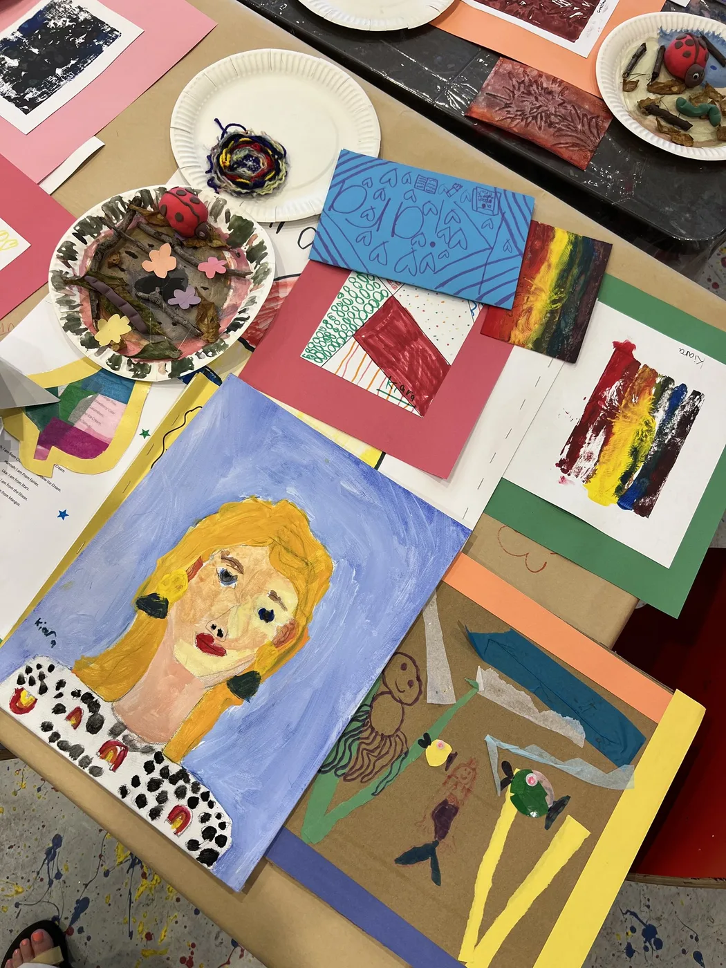 Camp portfolio with painted portrait and rainbow print