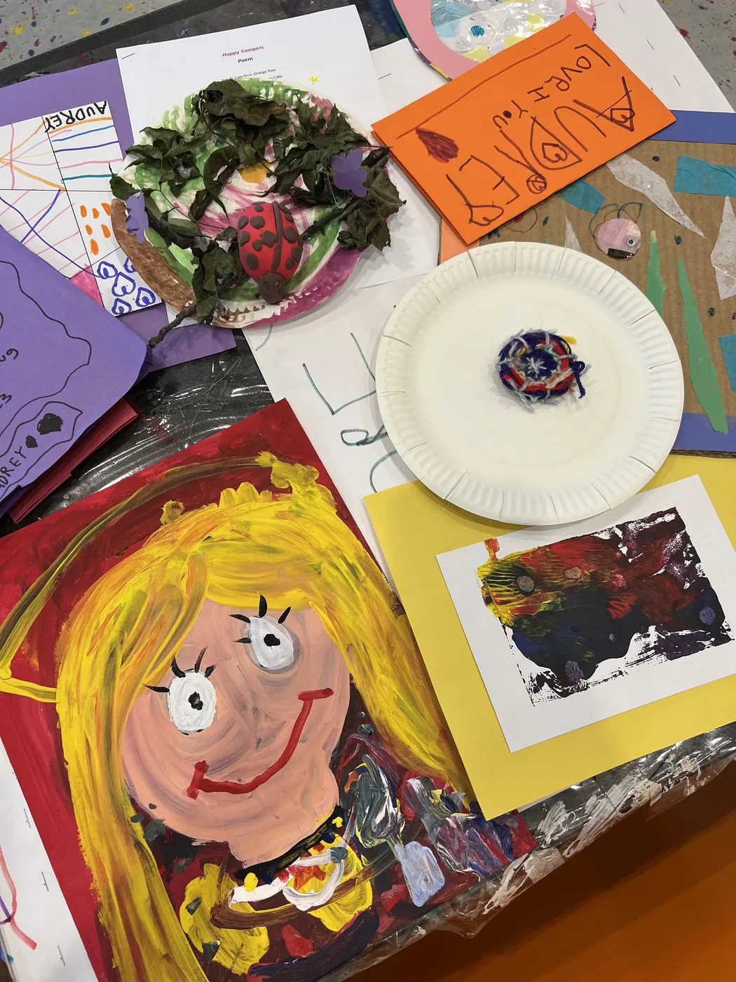 Camp portfolio with bright painted portrait and weaving
