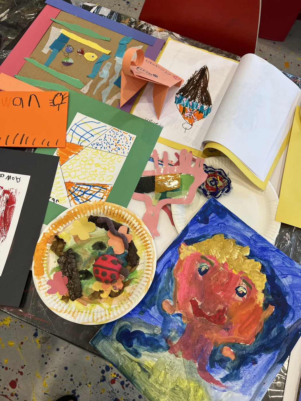 Camp portfolio with blue painted portrait and sketchbook