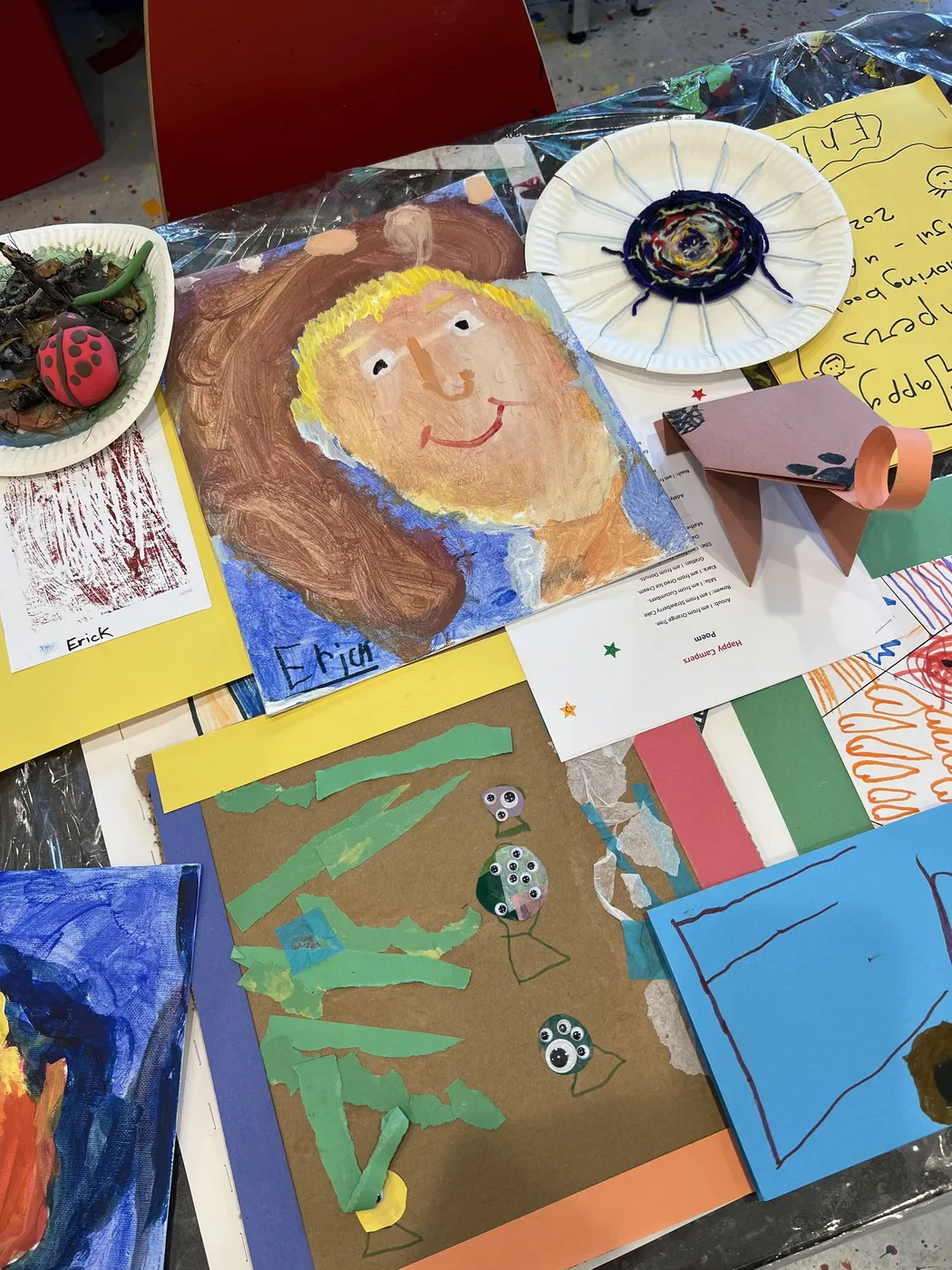 Camp portfolio with painted portrait and yarn plate