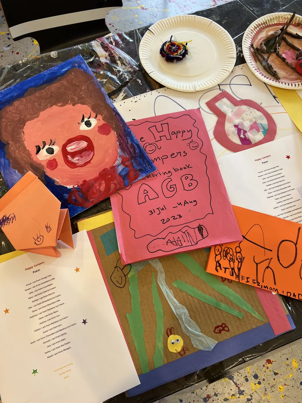 Camp portfolio with bold painted portrait and booklet