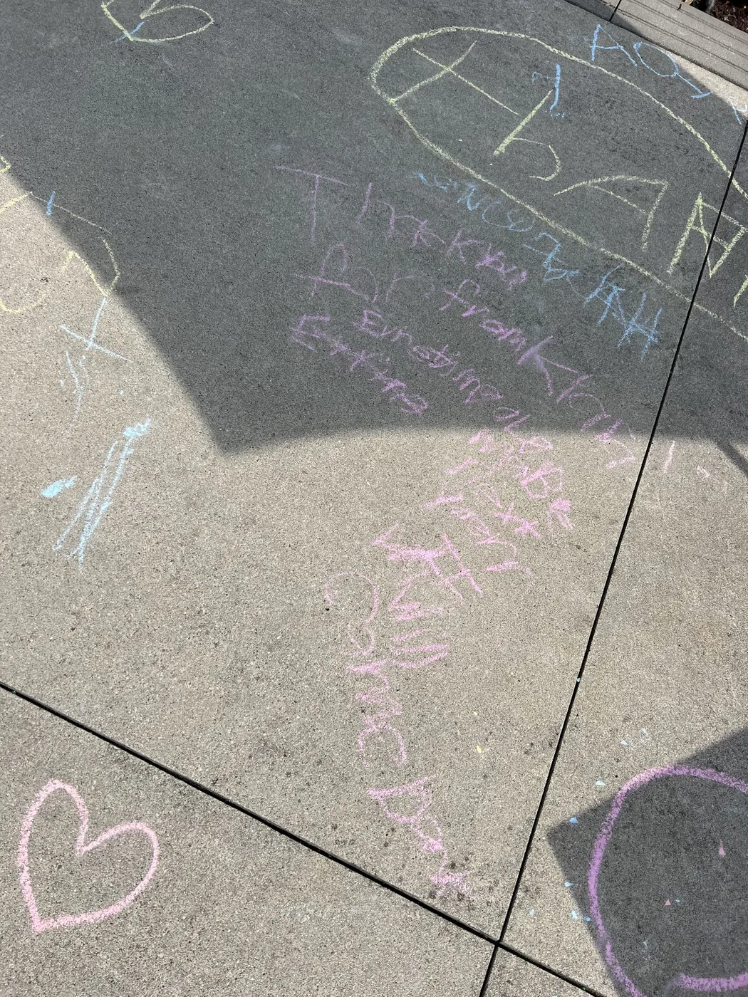 Chalk names and hearts written on pavement