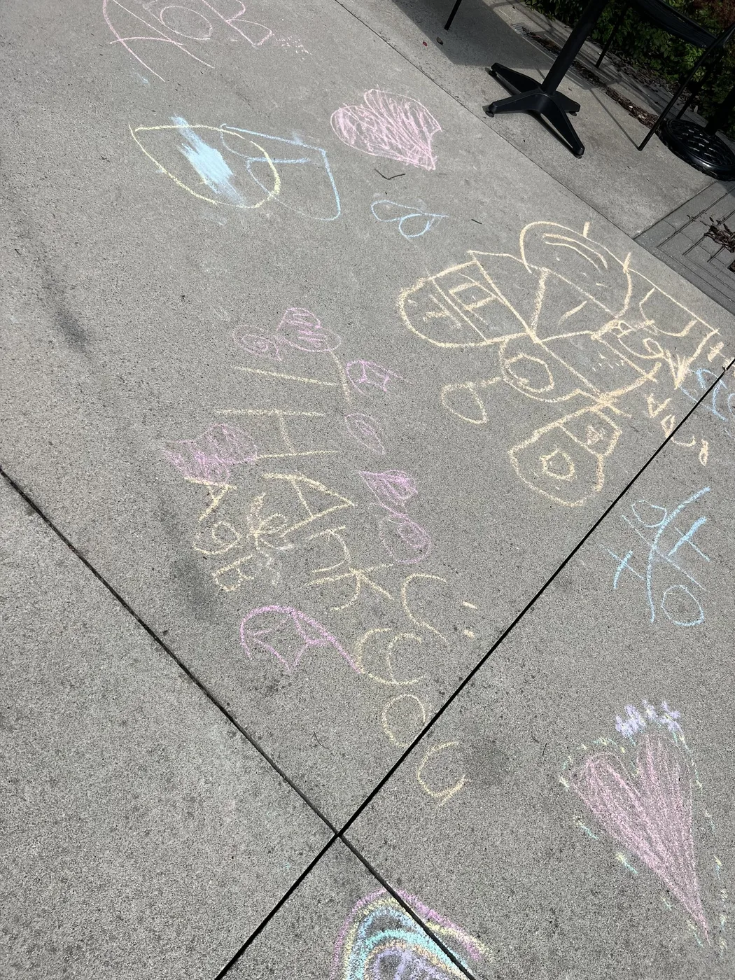 Chalk drawings and names on a sunny courtyard