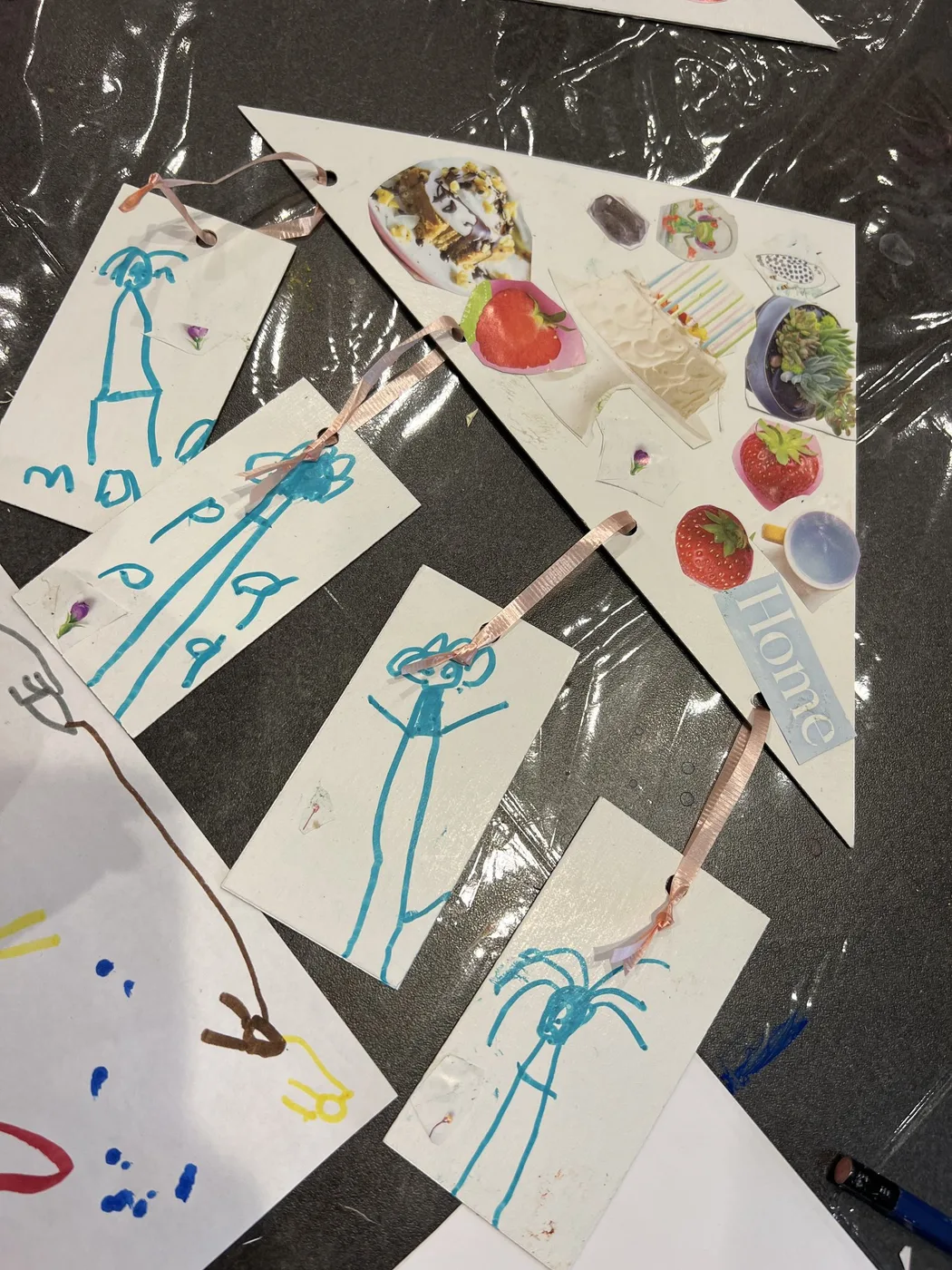Pennant with stick-figure tags and fruit collage