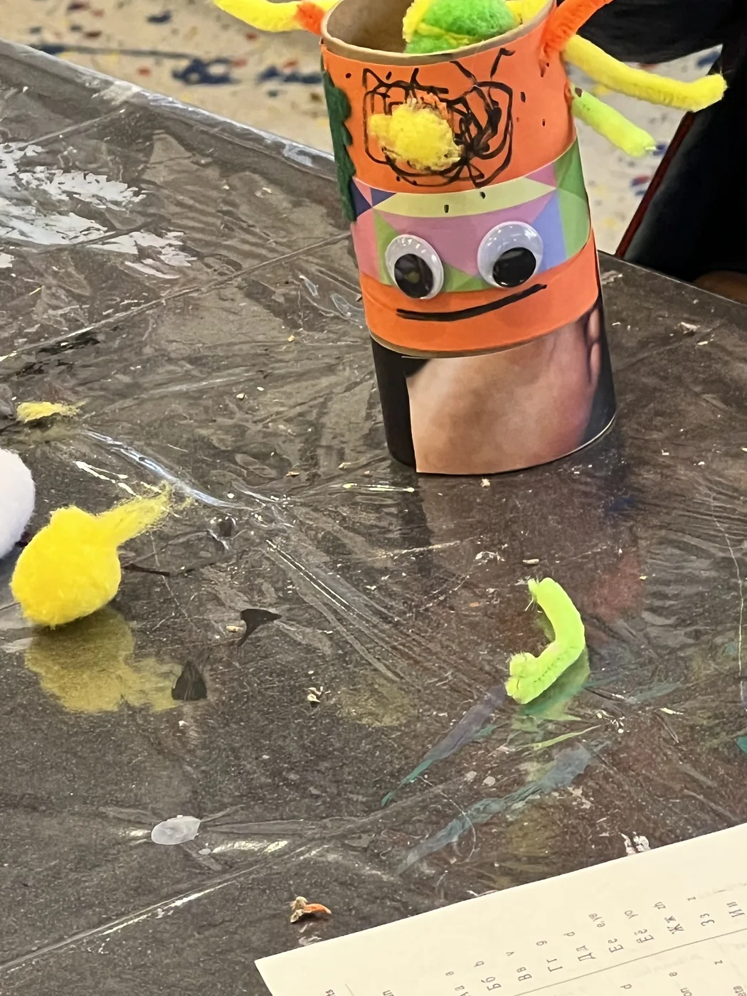 Orange tube character with googly eyes