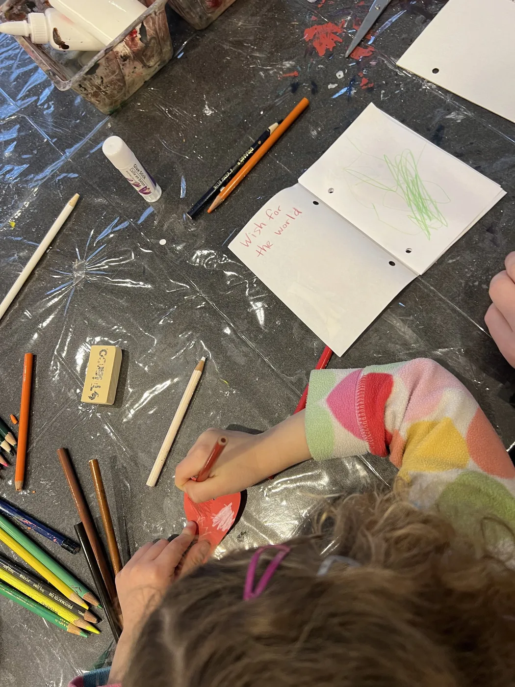 Child colouring a handmade wish book