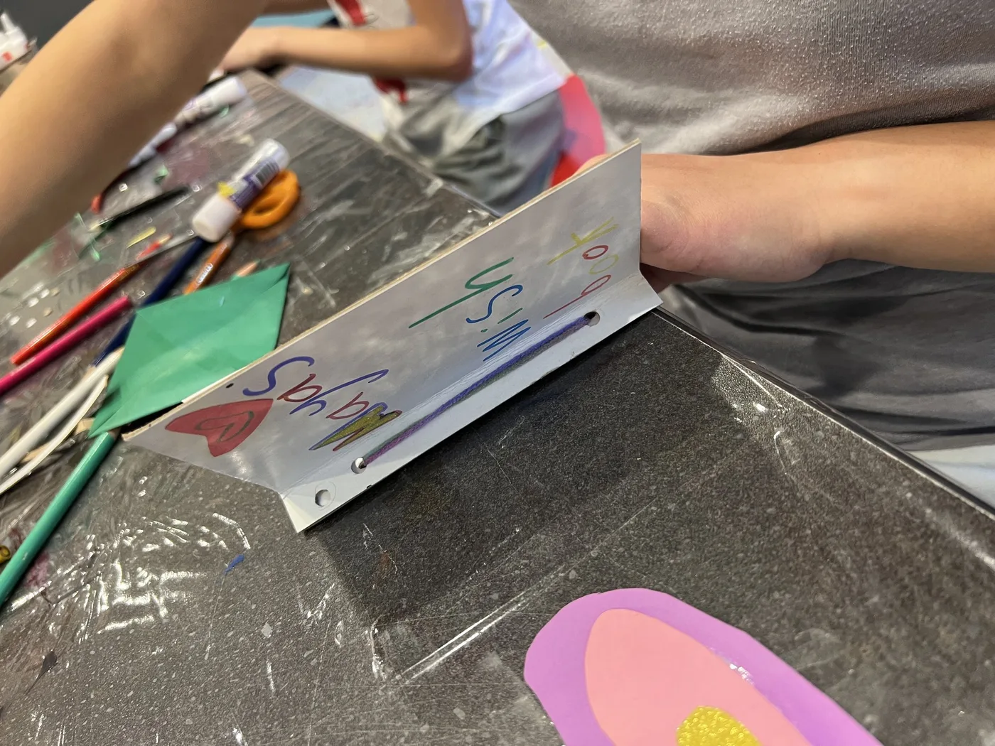 Hand holding open a lettered wish book