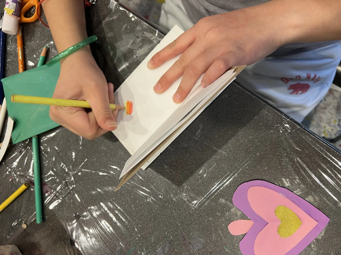 Hands drawing inside a handmade wish book
