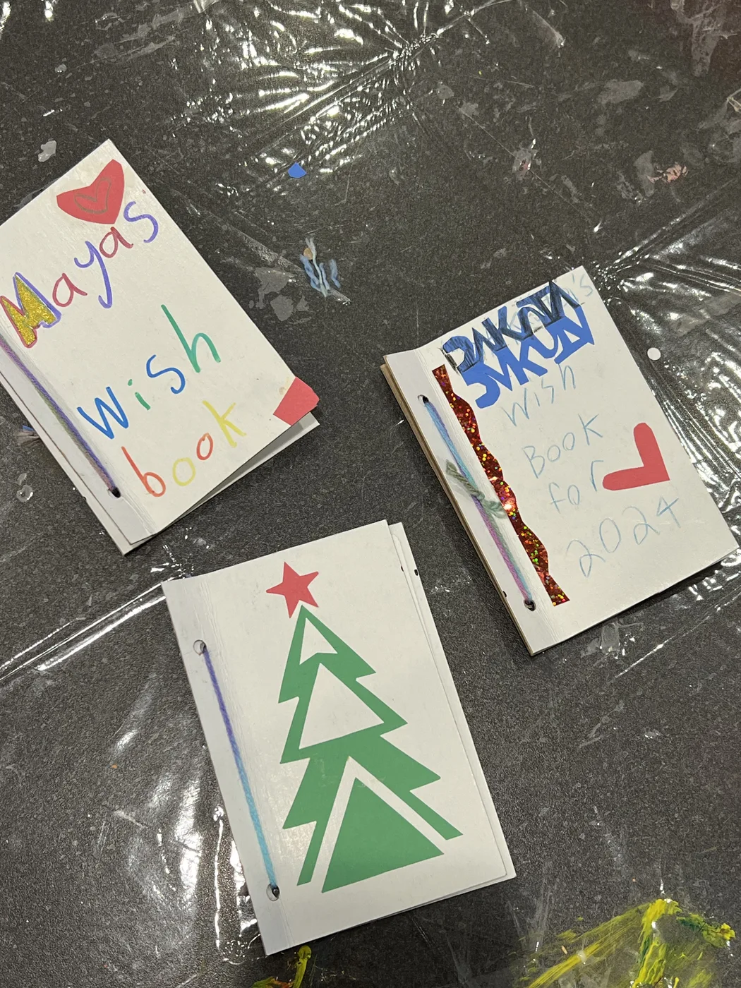 Three handmade wish books with tree and hearts