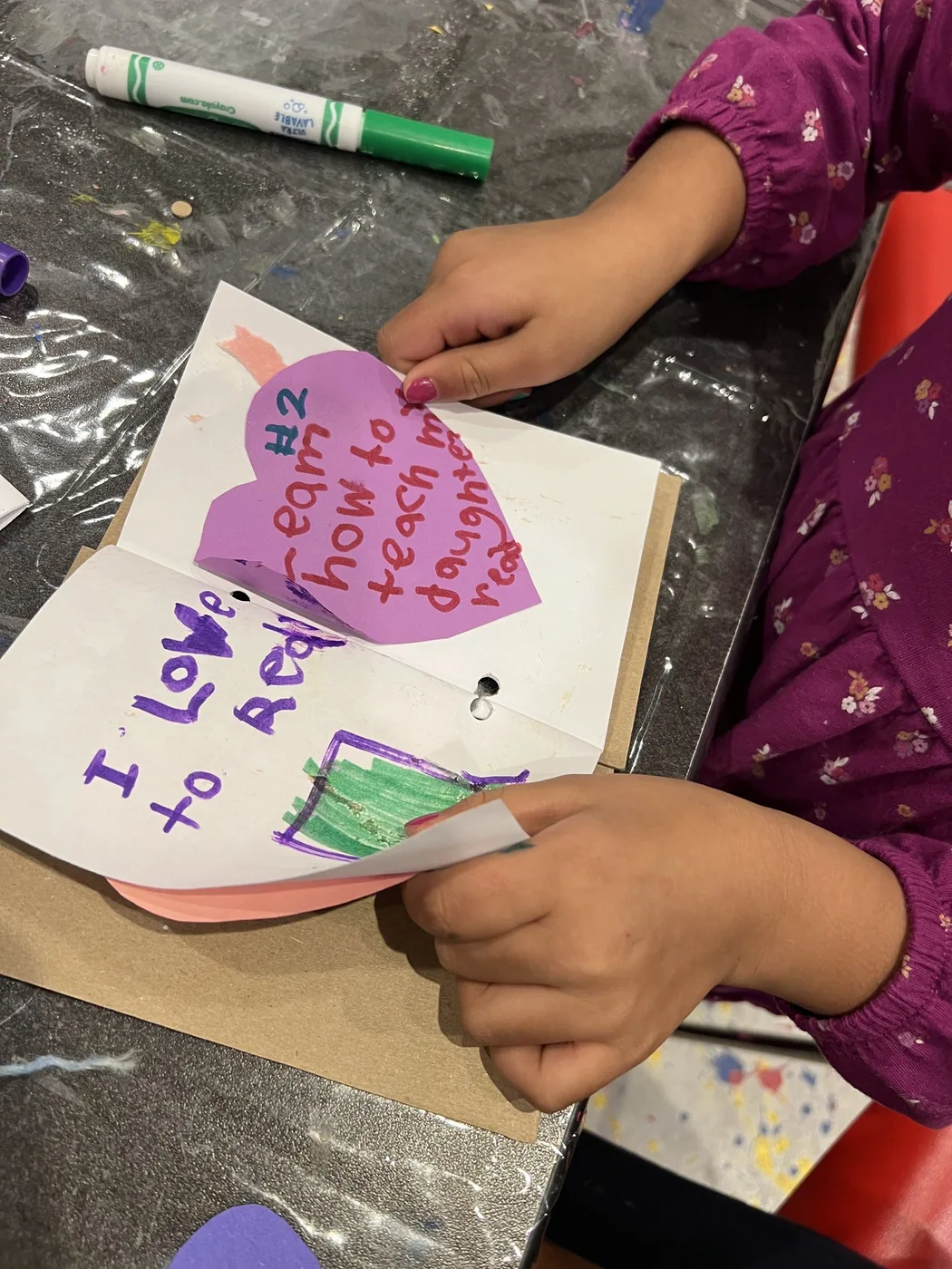 Hands turning pages of a handmade wish book