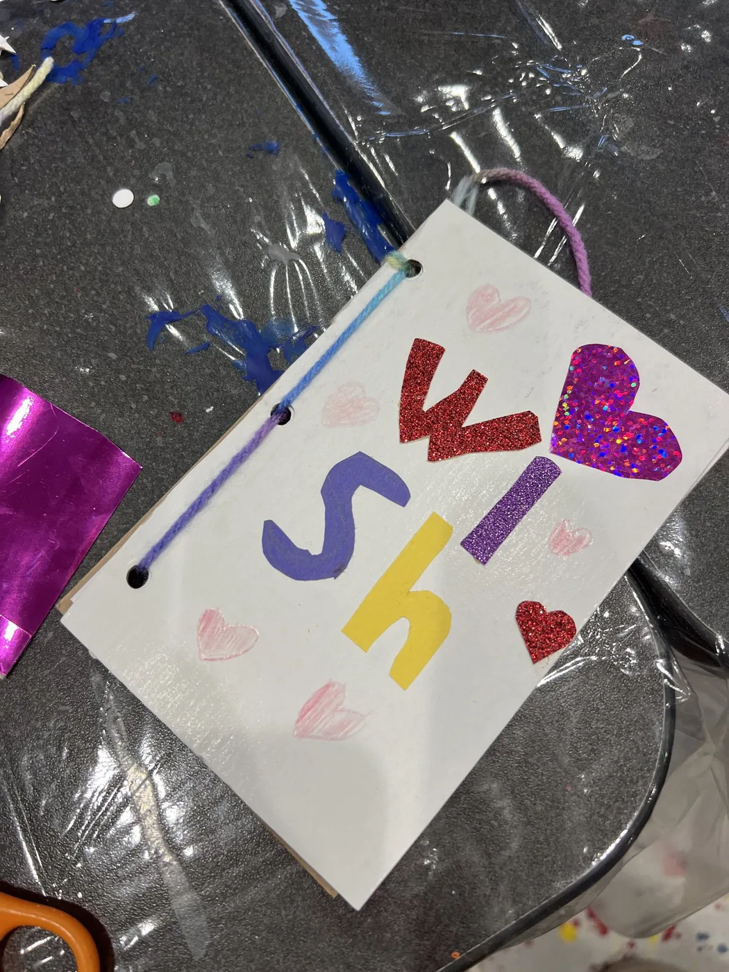 Wish book cover with glitter letters and hearts
