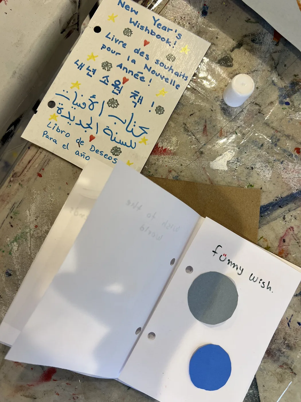 Multilingual New Year wish book with paper circles