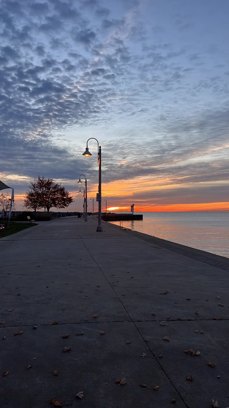 A waterfront path beneath an evening sky