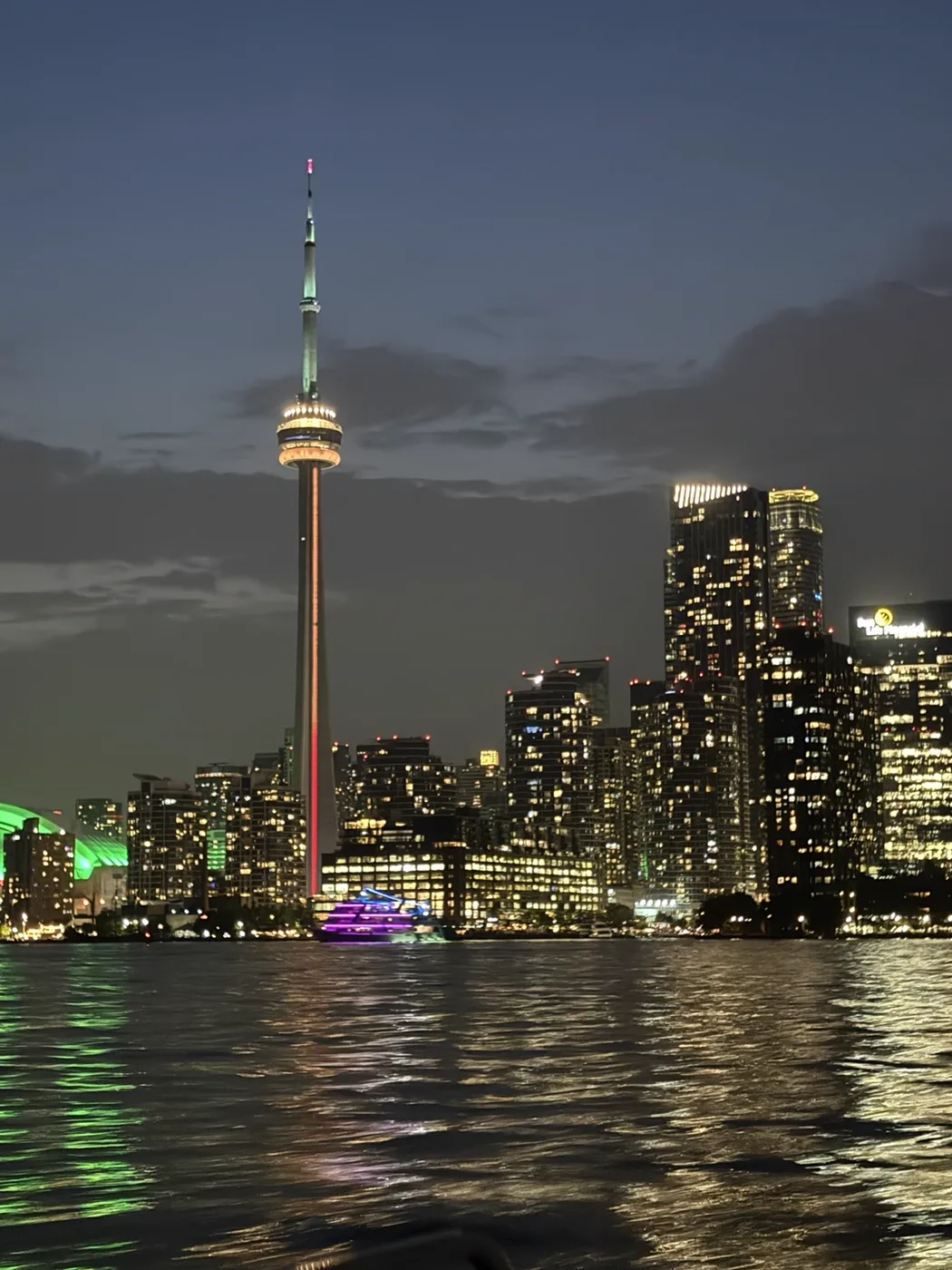 A city skyline reflected in the water at night