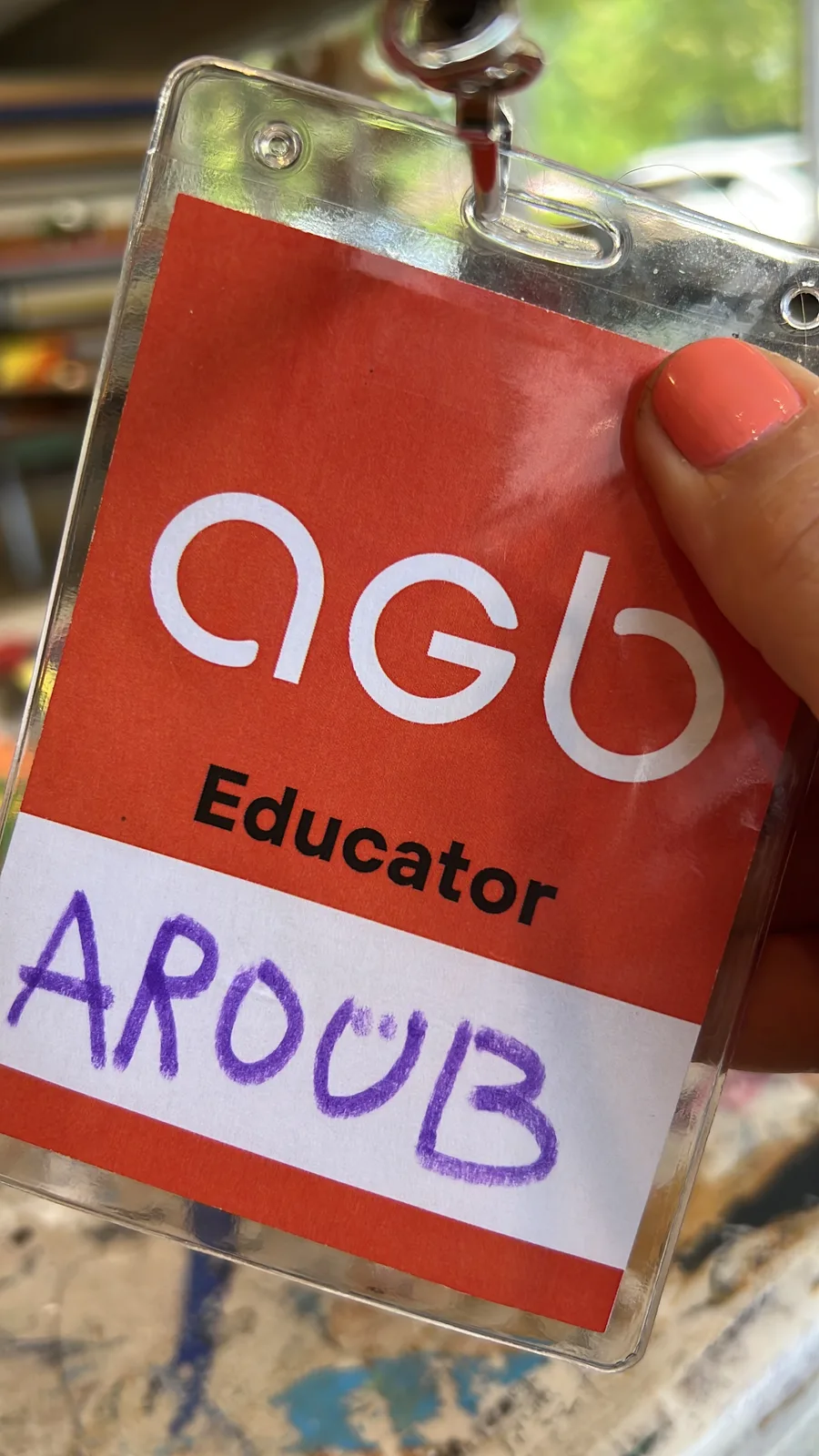 AGB Educator name badge reading AROUB, worn on a lanyard