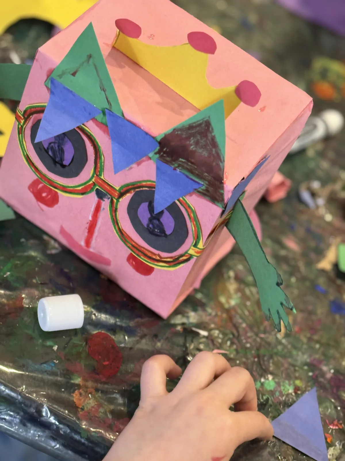 A pink paper box craft finished with glasses and a paper crown