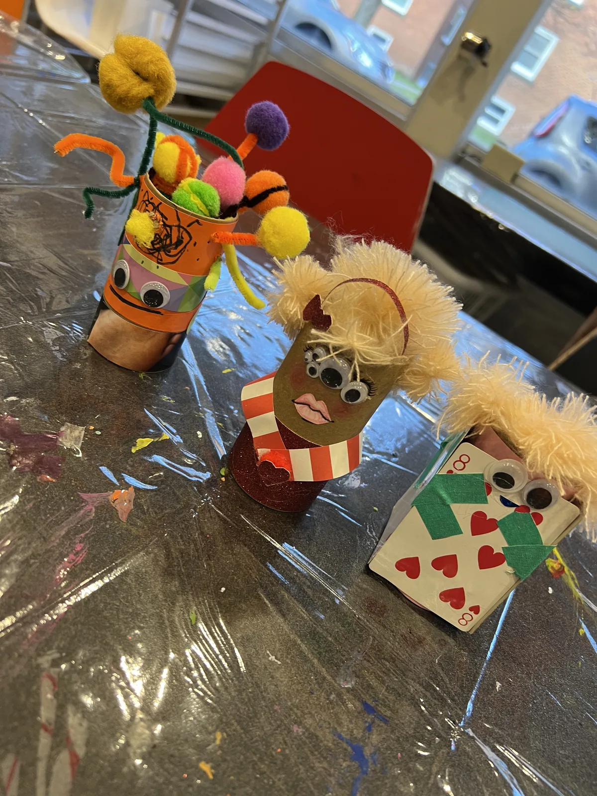 Three finished cardboard tube character figures with colourful pom-pom hair