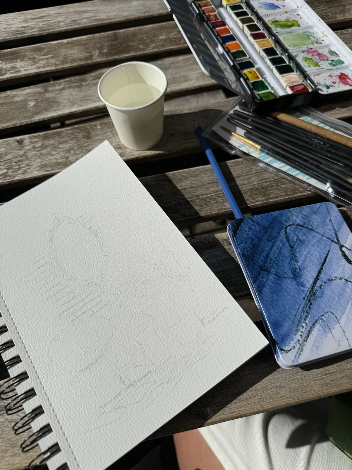 Pencil drawing of the courtyard in an open sketchbook