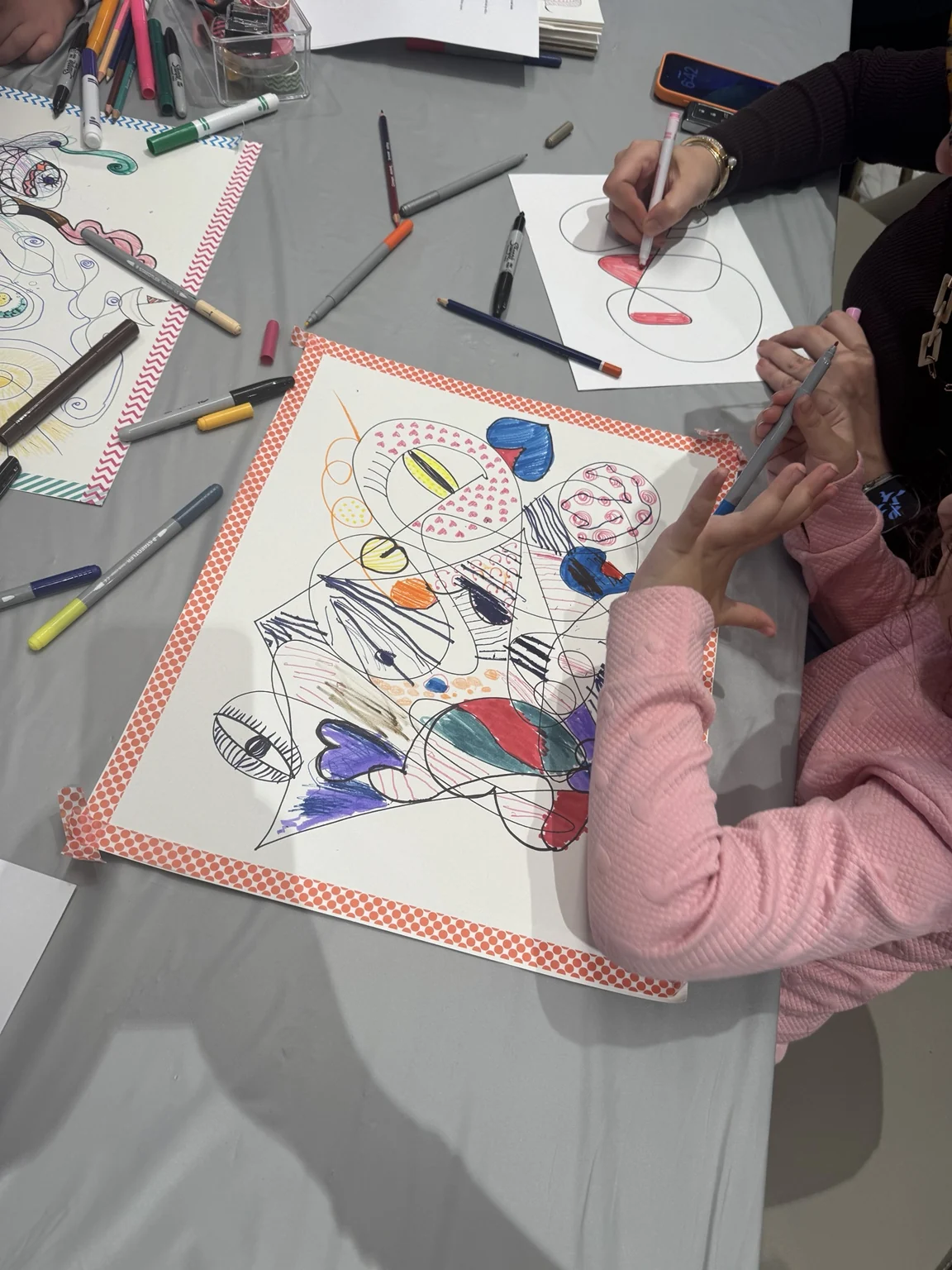 Drawing and colouring a doodle at the table