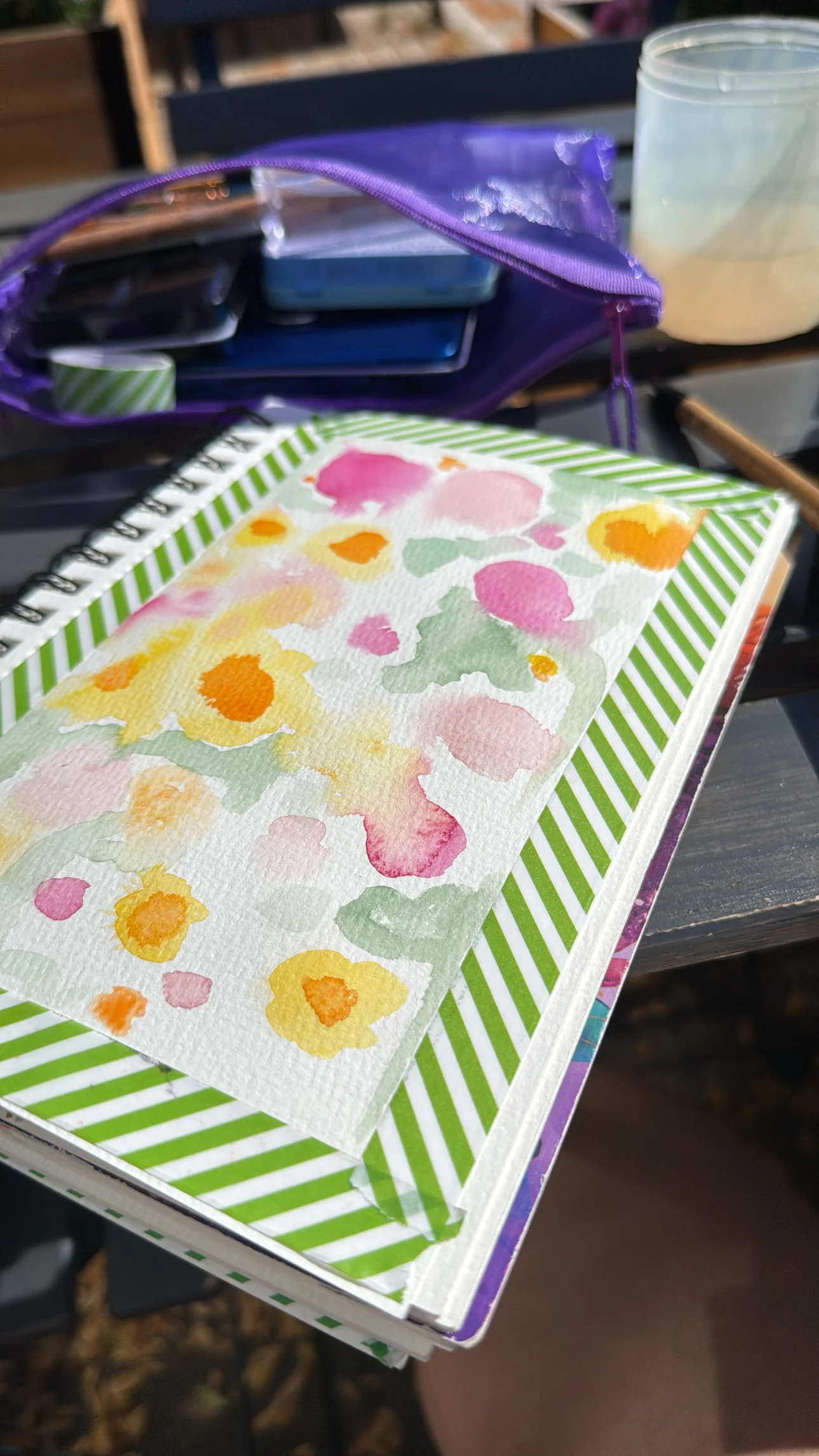 Early pink and yellow watercolour washes in a taped sketchbook