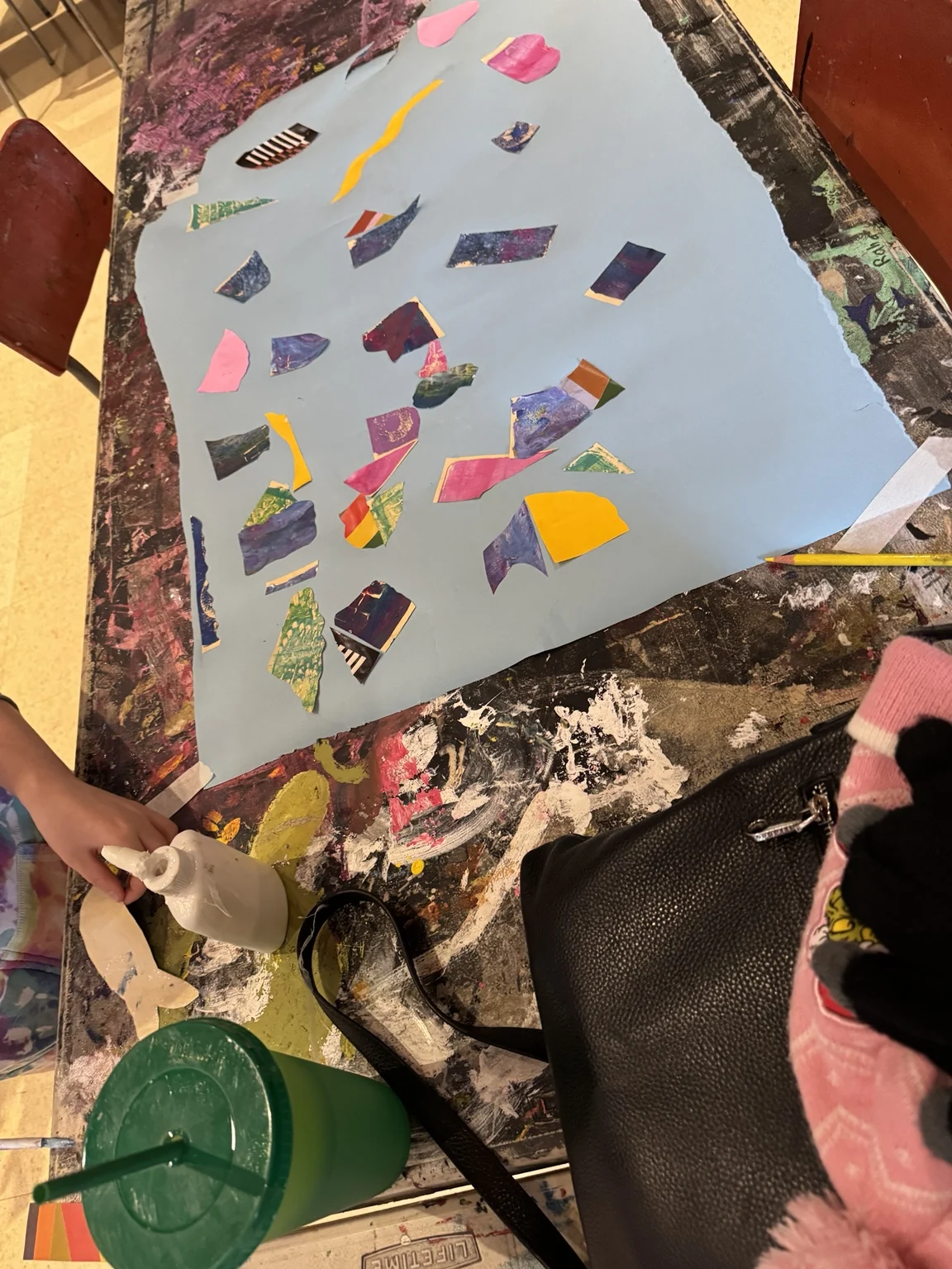 Arranging paper pieces into a collage