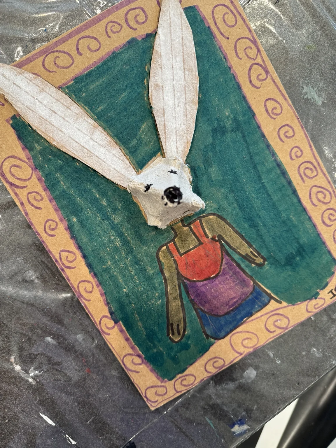 A long-eared character in a drawn frame.