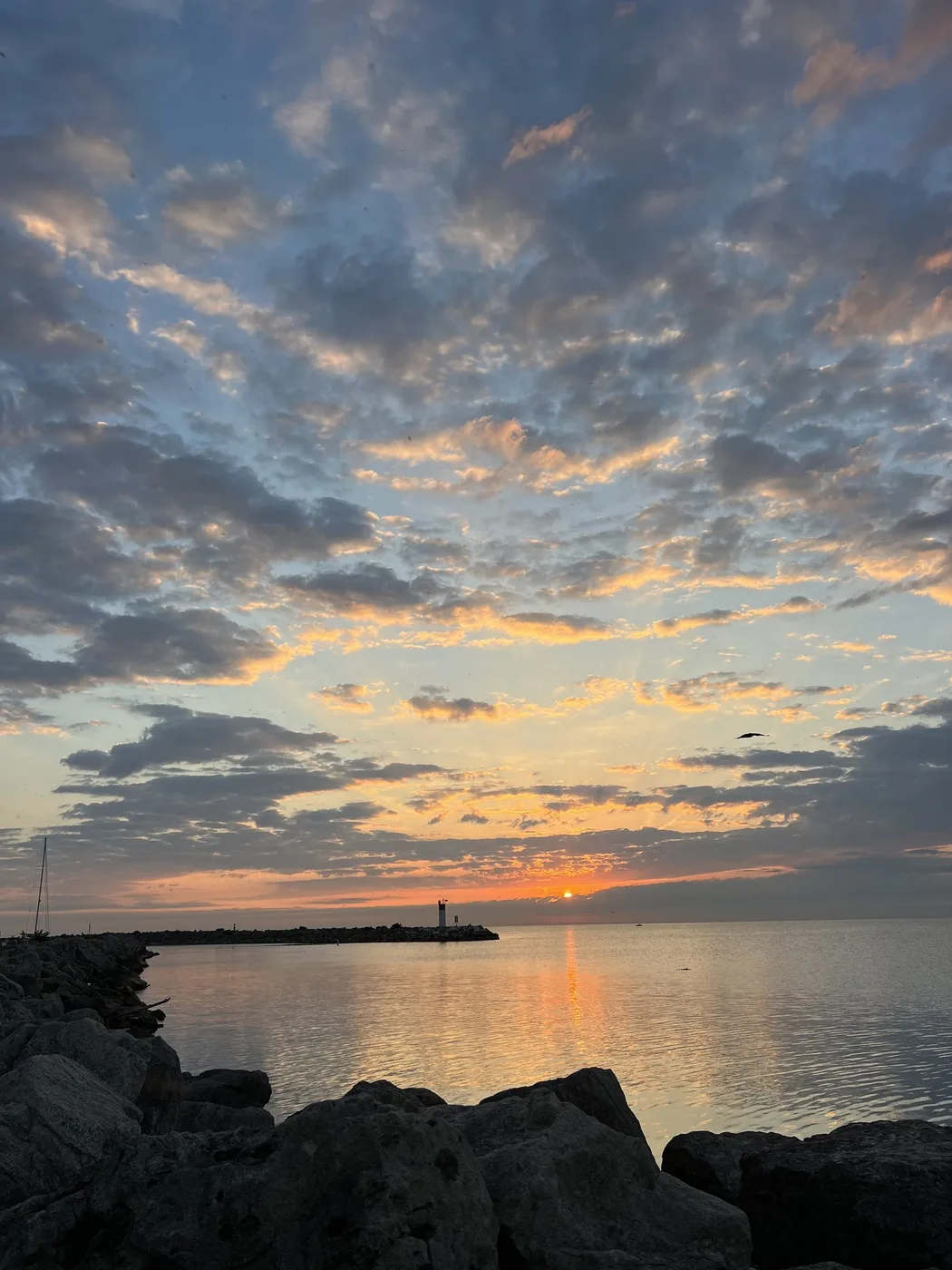 Clouds lit orange over the lake at sunset